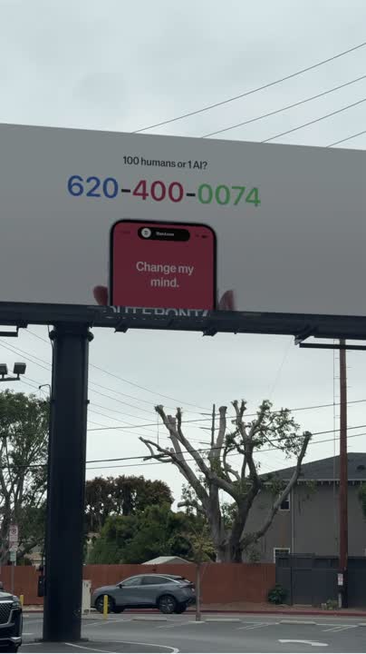 Billboard reading "100 humans or 1 AI?"
